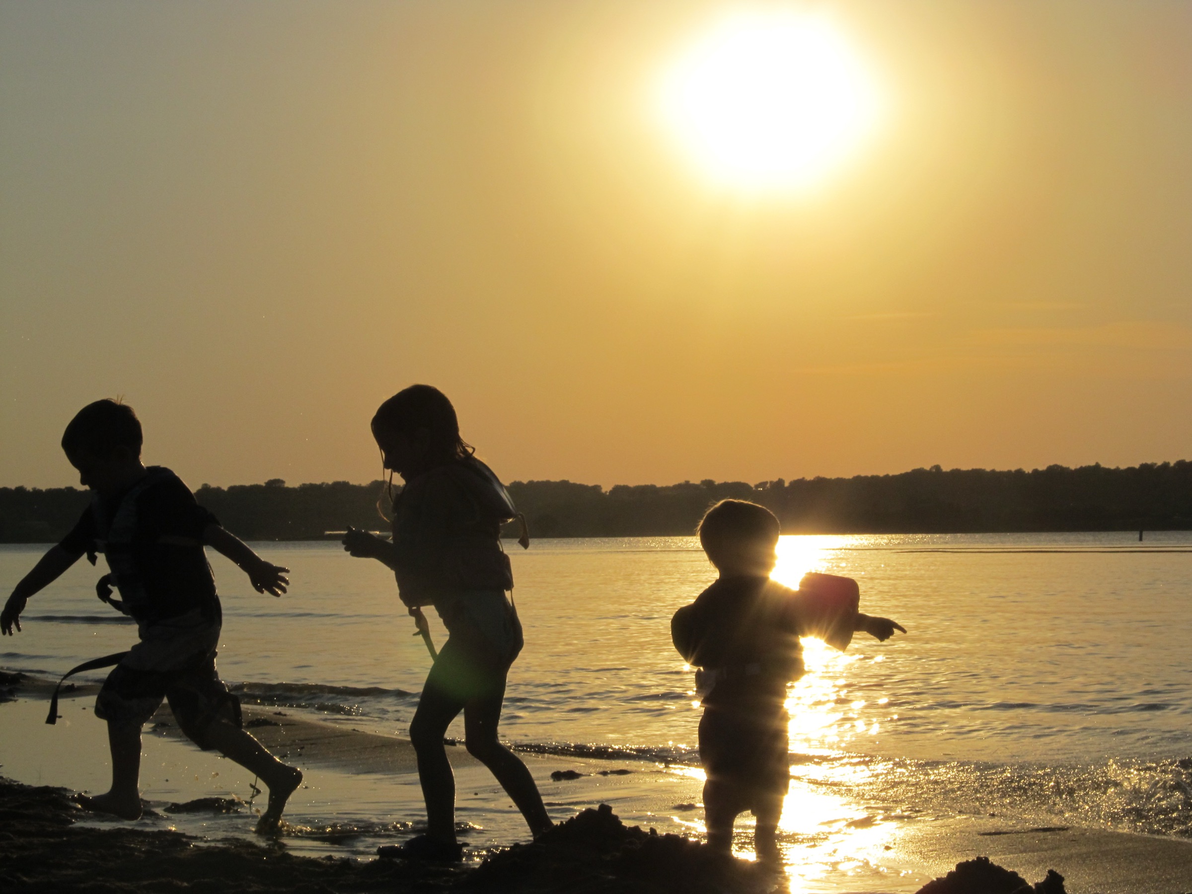 Kids playing at sunset on Kaw Lake shoreline